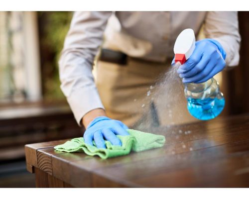 closeup-waitress-disinfecting-tables-outdoor-cafe (1)